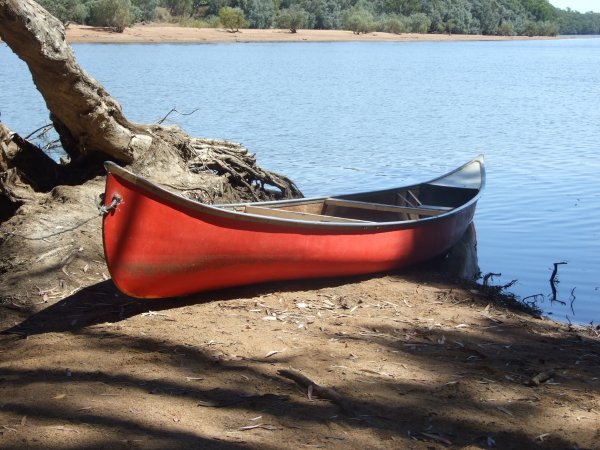 Canoe on river bank Canoe on riverbank