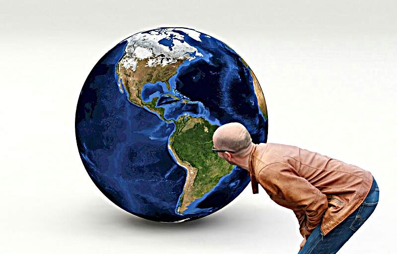 Earth Man staring at a giant globe